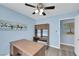 Bedroom with a ceiling fan, a built-in desk, and light blue walls at 2860 Misty Ct, Henderson, NV 89074