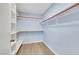 Walk-in closet with white shelves, hanging rods, and grey flooring at 2860 Misty Ct, Henderson, NV 89074