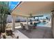 Covered patio overlooking a pool, with a ceiling fan and outdoor seating at 2860 Misty Ct, Henderson, NV 89074