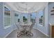 Charming dining area with bay windows and stylish ceiling fan fixture at 2860 Misty Ct, Henderson, NV 89074