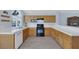 Well-lit kitchen featuring wooden cabinets, black appliances, and bright countertops at 2860 Misty Ct, Henderson, NV 89074