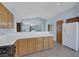 Bright kitchen with light wood cabinetry, tile countertops, and an open design at 2860 Misty Ct, Henderson, NV 89074