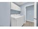 Laundry room featuring light blue walls, washer, dryer, and white cabinets above at 2860 Misty Ct, Henderson, NV 89074