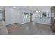 Open-concept living area with neutral paint, wood-look flooring, and access to kitchen at 2860 Misty Ct, Henderson, NV 89074