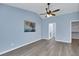 Primary bedroom with vaulted ceilings, light blue walls, and grey flooring at 2860 Misty Ct, Henderson, NV 89074