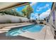 Backyard view of the pool and spa, with rock landscaping, and desert plants at 2860 Misty Ct, Henderson, NV 89074