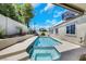 Backyard pool view, with spa, rock landscaping, and desert plants at 2860 Misty Ct, Henderson, NV 89074