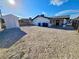 A spacious, sand-filled backyard featuring a detached shed and the home's rear exterior at 3215 Dillon Ave, North Las Vegas, NV 89030