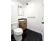 Half bathroom features a modern vanity, toilet, and black marble flooring at 3215 Dillon Ave, North Las Vegas, NV 89030