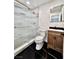 Stylish bathroom featuring a glass-enclosed shower, modern vanity, and sleek black marble flooring at 3215 Dillon Ave, North Las Vegas, NV 89030