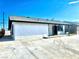 A white stucco home with black trim, contrasted against a blue sky, showcasing its clean exterior at 3215 Dillon Ave, North Las Vegas, NV 89030