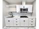 Updated kitchen features white cabinets, sleek black hardware, stainless appliances, and modern subway tile backsplash at 3215 Dillon Ave, North Las Vegas, NV 89030
