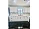 Modern kitchen featuring white cabinets, subway tile backsplash, stainless steel sink and black marble floor at 3215 Dillon Ave, North Las Vegas, NV 89030