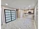 Bright living area with modern kitchen, marble floors, and contemporary sliding door closet at 3215 Dillon Ave, North Las Vegas, NV 89030