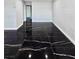 Spacious room showcasing sleek black marble floors and fresh, light walls at 3215 Dillon Ave, North Las Vegas, NV 89030