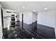 Open-concept living area featuring sleek black marble floors that extend into the modern kitchen at 3215 Dillon Ave, North Las Vegas, NV 89030