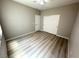Cozy bedroom featuring light-colored walls, modern flooring, closet, and ceiling fan with light fixture at 3221 Villa Pisani Ct, North Las Vegas, NV 89031