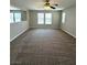 Versatile bonus room featuring neutral walls, plush carpeting, and large windows for ample natural light at 3221 Villa Pisani Ct, North Las Vegas, NV 89031