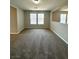 Versatile bonus room featuring neutral walls, plush carpeting, and large windows for ample natural light at 3221 Villa Pisani Ct, North Las Vegas, NV 89031
