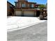 Two-story home with large three car garage, desert landscaping, and beautiful architecture at 3221 Villa Pisani Ct, North Las Vegas, NV 89031