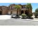 Two-story home with large three car garage, desert landscaping, and beautiful architecture at 3221 Villa Pisani Ct, North Las Vegas, NV 89031