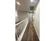 Carpeted hallway with white railing, neutral walls, and recessed lighting at 3221 Villa Pisani Ct, North Las Vegas, NV 89031