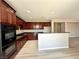 Spacious kitchen featuring dark cabinetry, modern appliances, and an open design perfect for entertaining at 3221 Villa Pisani Ct, North Las Vegas, NV 89031