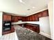 Well-equipped kitchen featuring stainless steel appliances, granite countertops, and ample cabinet space at 3221 Villa Pisani Ct, North Las Vegas, NV 89031