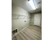 Functional laundry room with shelving, neutral paint, and wood-look flooring at 3221 Villa Pisani Ct, North Las Vegas, NV 89031