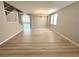 Open-concept living room with wood-look floors, chandelier, and staircase at 3221 Villa Pisani Ct, North Las Vegas, NV 89031