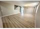 Large living room with wood-look floors, neutral paint, chandelier, and stairway at 3221 Villa Pisani Ct, North Las Vegas, NV 89031
