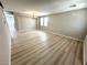 Bright and airy living room with wood-look floors, chandelier, and neutral paint at 3221 Villa Pisani Ct, North Las Vegas, NV 89031