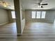 Large living room showcasing laminate flooring, open layout, and natural light from the windows at 3221 Villa Pisani Ct, North Las Vegas, NV 89031