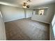 Large living room boasts neutral walls and plush carpeting, with clear sight lines to nearby spaces at 3221 Villa Pisani Ct, North Las Vegas, NV 89031