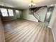 Spacious living room featuring wood-look floors, staircase, and bright windows at 3221 Villa Pisani Ct, North Las Vegas, NV 89031