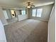 Large living room showcases neutral walls and plush carpeting, with clear sight lines to nearby spaces at 3221 Villa Pisani Ct, North Las Vegas, NV 89031