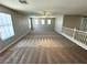 Spacious loft area with modern ceiling fan, plush carpeting, and ample natural light from multiple windows at 3221 Villa Pisani Ct, North Las Vegas, NV 89031