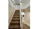 Elegant staircase with carpeted steps and white railings, leading to the upper level of the home at 3221 Villa Pisani Ct, North Las Vegas, NV 89031