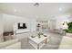 Airy living room showcasing open floor plan to kitchen and dining areas at 3270 Trabia Ave, Henderson, NV 89044
