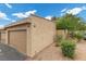 A tan stucco exterior with a single car garage, desert landscaping, and a tiled roof at 3363 Pavlo St, Las Vegas, NV 89121