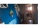 Hallway with blue walls and artwork leading to a sunlit bedroom at 3363 Pavlo St, Las Vegas, NV 89121