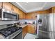Traditional kitchen with wood cabinetry, stainless steel appliances, and neutral countertops at 3363 Pavlo St, Las Vegas, NV 89121