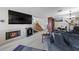 Open-concept living area with a fireplace, tv, and stairs leading to the upper level at 3363 Pavlo St, Las Vegas, NV 89121