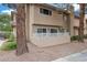 Private patio area with a low white fence, mature plants, and a glimpse of the building's exterior at 3363 Pavlo St, Las Vegas, NV 89121