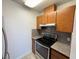 Galley kitchen featuring wood cabinets, electric range, and granite countertops at 3606 Di Salvo Dr # 133, Las Vegas, NV 89103