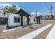 Side view of the white home with black trim and a bright yellow front door at 365 N 16Th St, Las Vegas, NV 89101