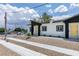 A bright single-story home boasts curb appeal with its fresh exterior and minimalist landscaping at 365 N 16Th St, Las Vegas, NV 89101