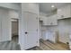 The kitchen features bright white cabinets with black hardware and wood-look flooring at 365 N 16Th St, Las Vegas, NV 89101