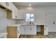Bright kitchen with white cabinets, countertops, a modern faucet, and wood-look flooring at 365 N 16Th St, Las Vegas, NV 89101