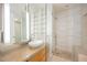 Modern bathroom with a glass shower, floating vanity, and shelving for storage at 3726 Las Vegas Blvd # 704, Las Vegas, NV 89158